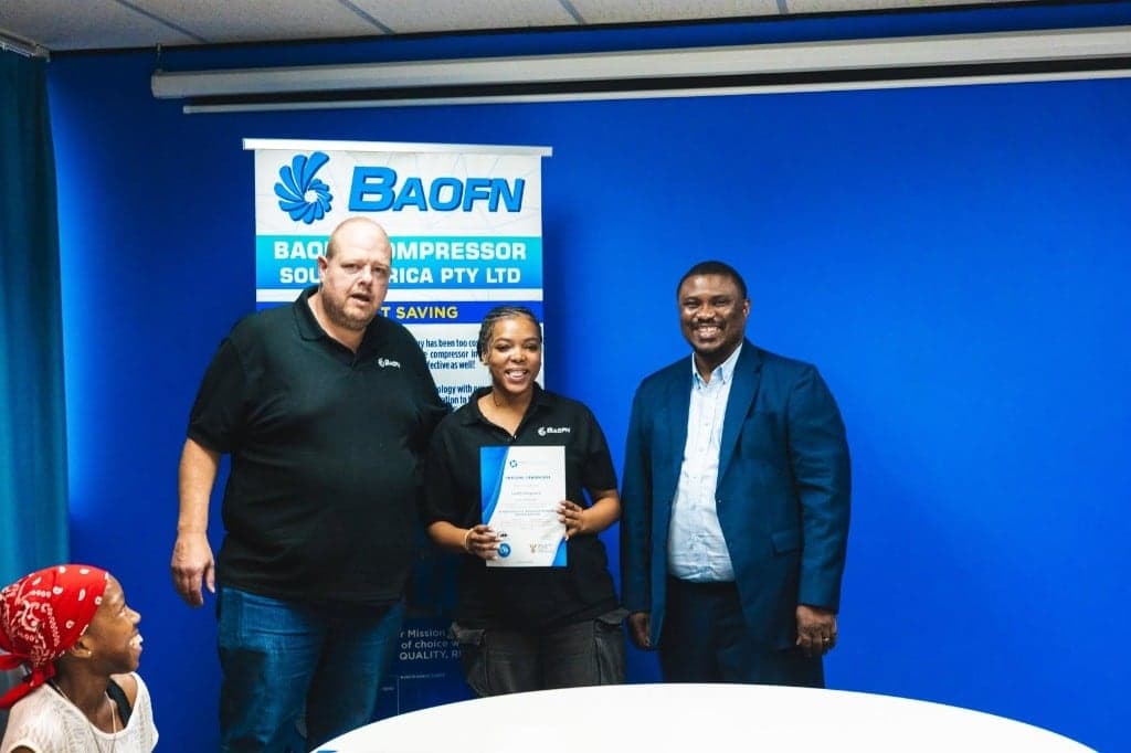 A BAOFN certificate presentation with staff and a community partner